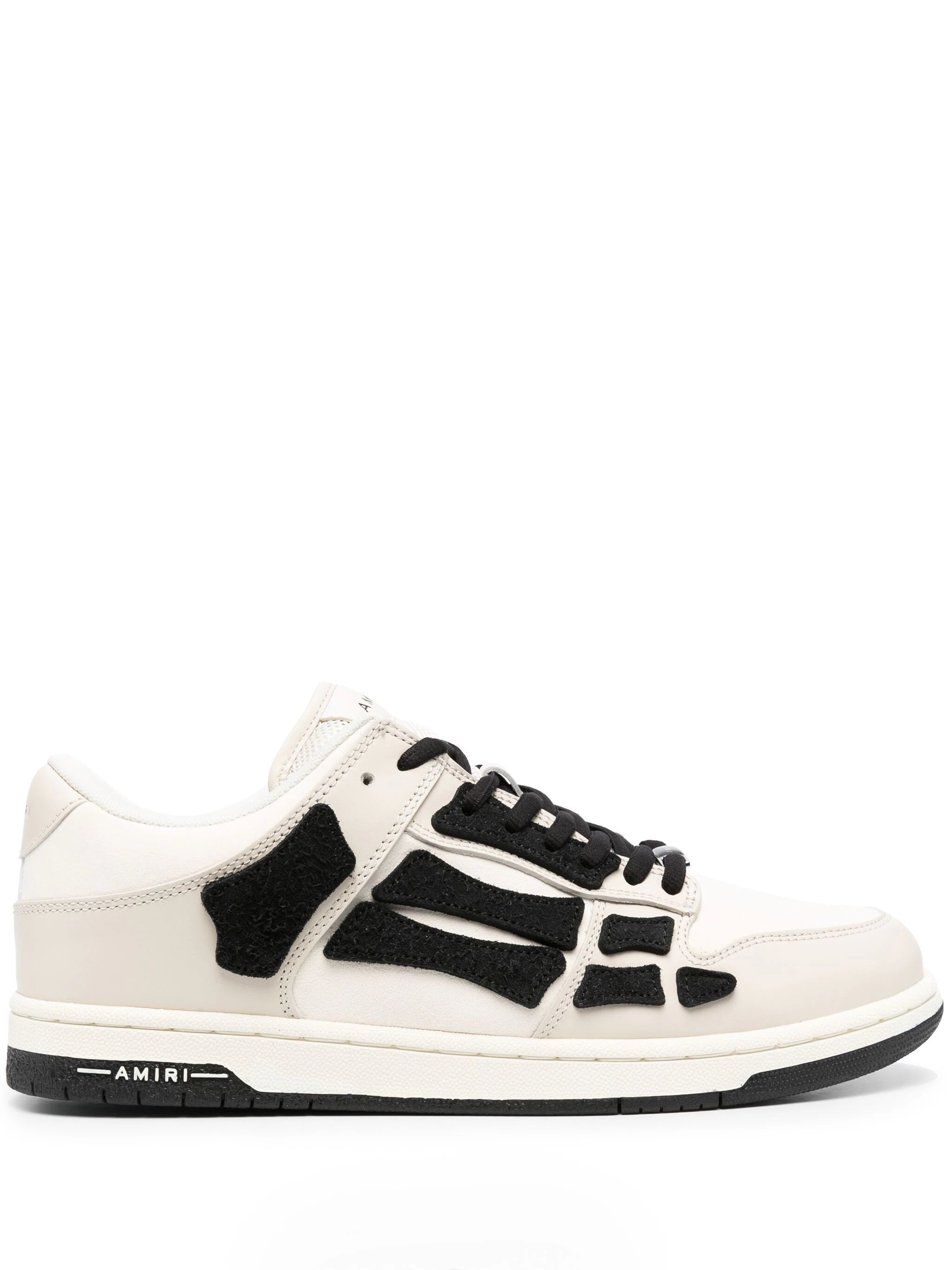 Front view of stylish low top skeleton leather sneakers showcasing the unique design and embroidered patch.